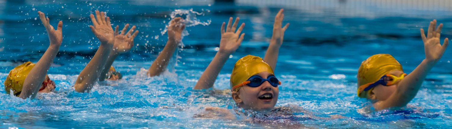 Olympium Artistic Swimming Club team performing synchronized routine