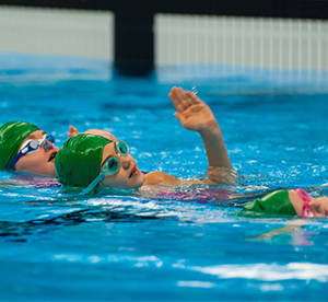 Young swimmers learning artistic swimming fundamentals